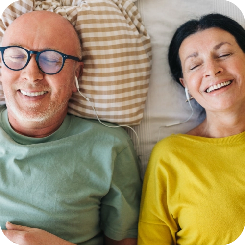 Two people listening to music together with headphones